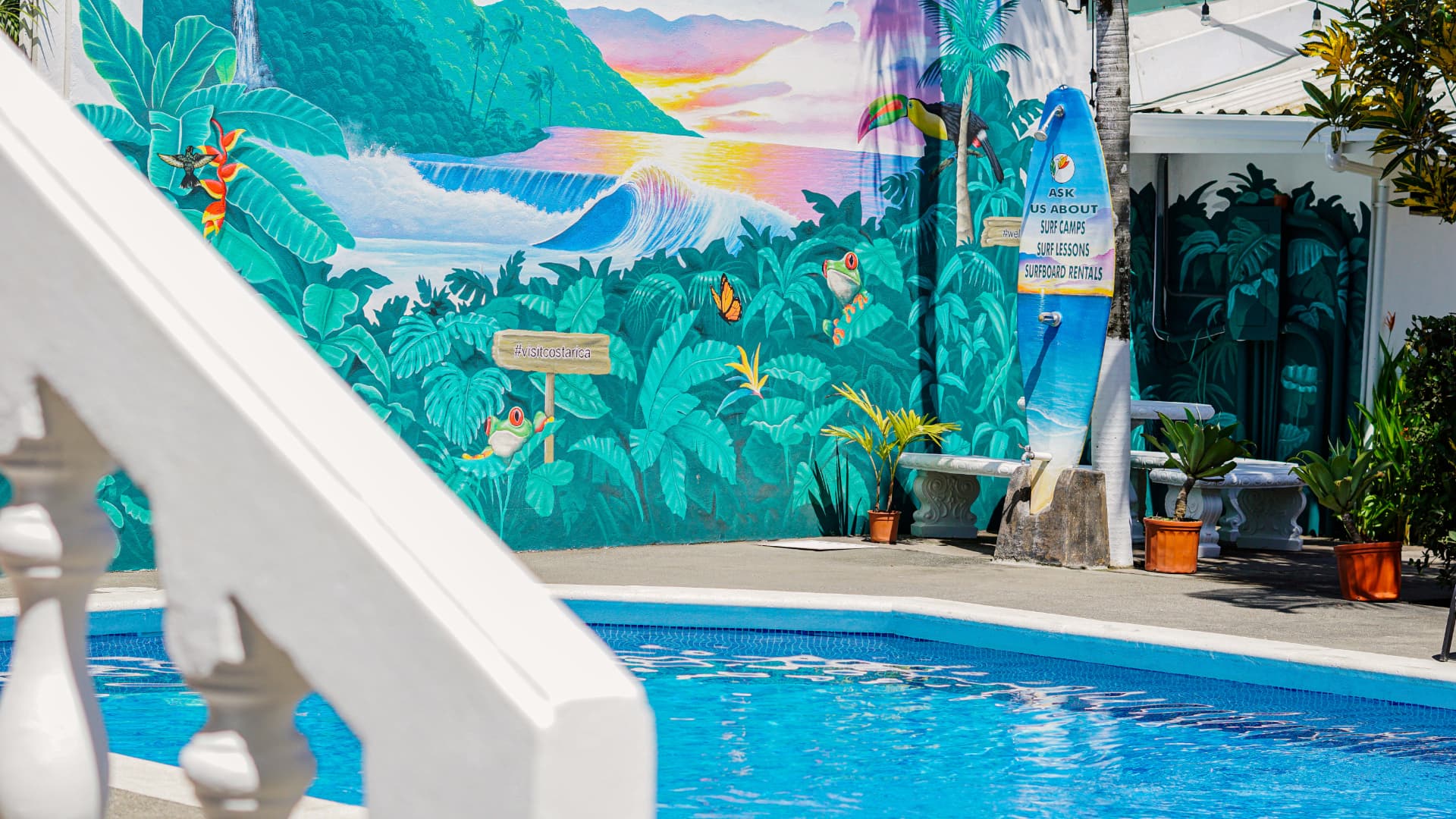 Hand-painted murals on the courtyard walls at Bird of Paradise Hotel